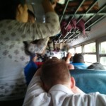 Dennis trying to catch some sleep on a busy chicken bus